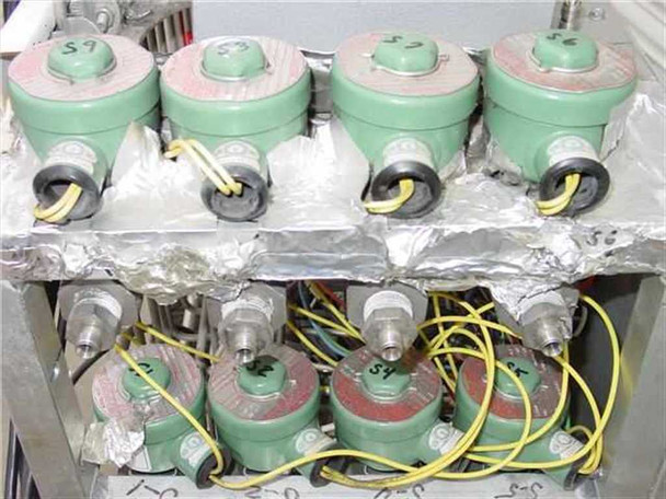 Close-up of four green Validyne AP10-48 pressure control valves wired with yellow leads inside XP16