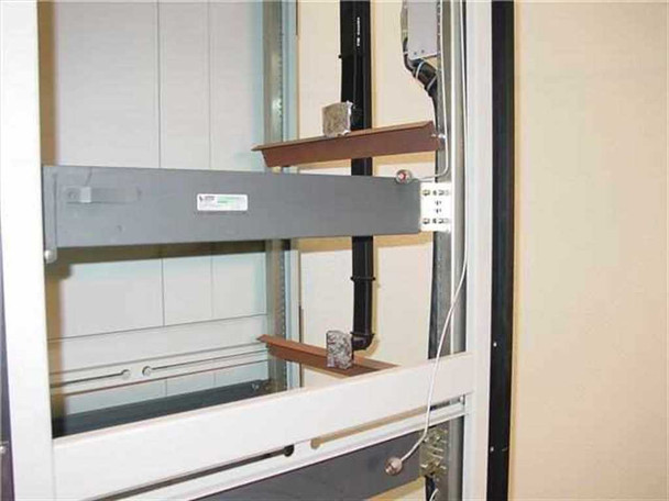 Varian 1015230 rackmount cabinet interior close-up showing horizontal waveguide rail, RF connector panel, and internal wiring