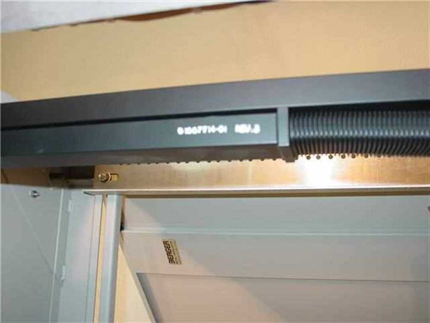Varian 1007713-01 RF waveguide close-up showing part number and REV.B marking on black waveguide housing with corrugated flex conduit