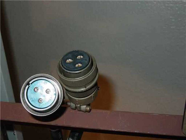 Varian 1015230 cabinet detail showing mil-spec circular connectors on a waveguide shelf bracket — one male connector body and one female receptacle visible