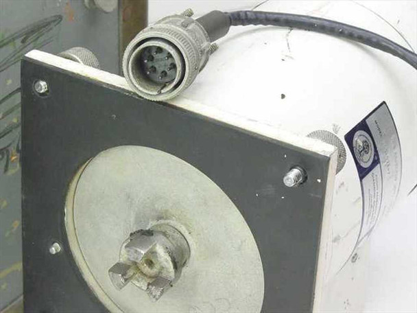 Close-up of Giannini Scientific 205-071-7 motor front face showing flange mounting plate, output shaft, and attached multi-pin circular connector with cable