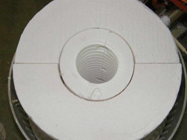 Top-down view of white ceramic fiber insulation end ring assembly — two-piece ring with threaded ceramic tube insert, showing 2-inch bore; slight crack visible in insulation ring