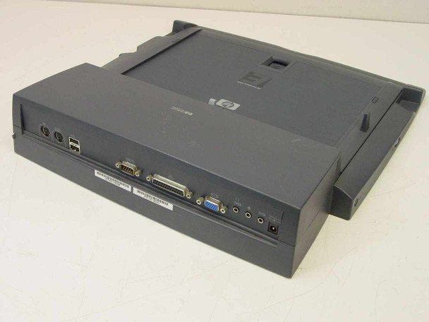 HP F1451A OmniBook Port Replicator — rear 3/4 view showing PS/2, USB, serial, parallel, VGA, audio, and power ports