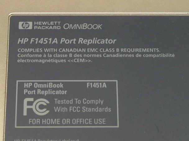 HP F1451A Port Replicator label closeup showing model number, FCC compliance, and Canadian EMC Class B certification