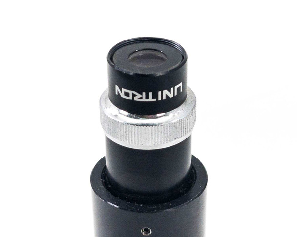 Close-up of Unitron branded eyepiece with silver knurled focus ring on optical tube