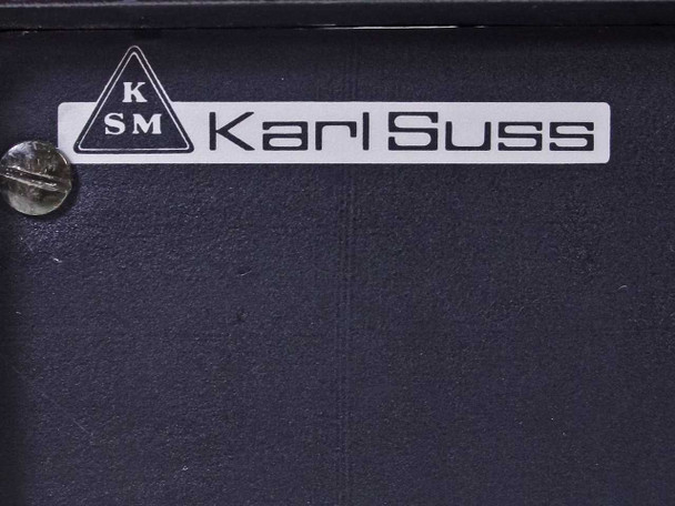 Karl Suss logo badge close-up on dark panel — KSM triangle logo and Karl Suss name