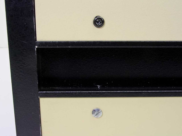 Karl Suss controller housing corner detail — black rail and cream panel showing screw hardware and minor wear