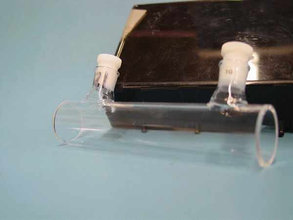 McCarthy Scientific Type 34 precision cells — side view of two matched quartz cells with white caps resting against black case, showing cylindrical body and open ends
