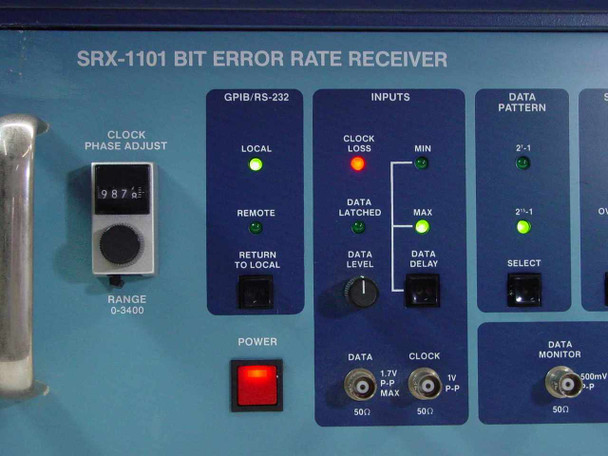 Tau-Tron SRX-1101 front panel close-up – GPIB/RS-232 section, Inputs section with BNC connectors, clock phase adjust dial reading 987