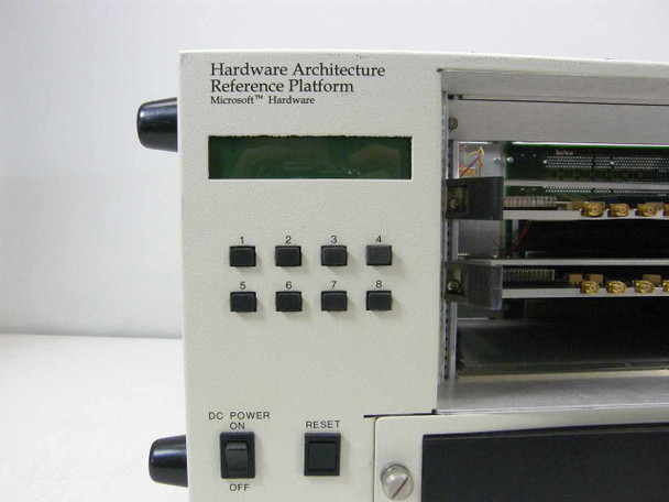 APW HARP chassis front panel close-up showing 'Hardware Architecture Reference Platform Microsoft Hardware' label, 8 numbered buttons, LCD display, DC Power On/Off switch, and Reset button