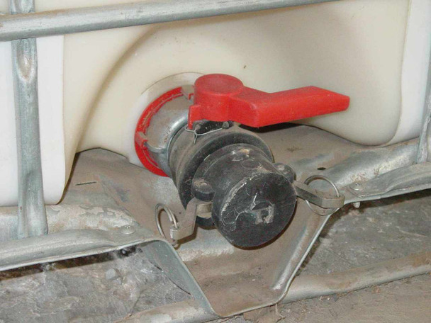 Trustor Coatings 6900 IBC tote – close-up of red lever ball valve outlet fitting at base of tote
