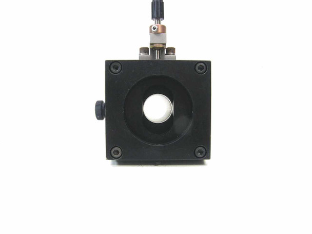 Front face of linear stage optical mount showing large circular bore opening for optical tube and four corner mounting holes