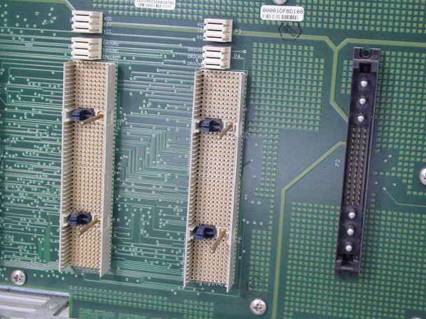 Cabletron 6C105 backplane close-up — three large card-edge module connectors and one smaller connector visible on green PCB