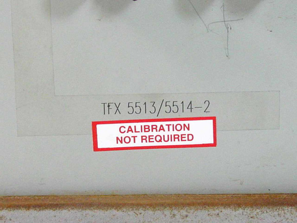 TFX 5513/5514-2 part number label and Calibration Not Required sticker with surface rust visible on enclosure bottom rail