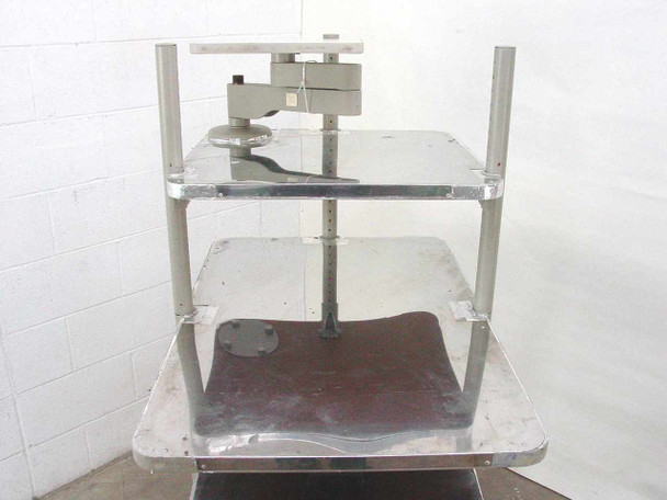 Anthro rolling computer cart rear view showing adjustable monitor arm mechanism and shelf surfaces with wear