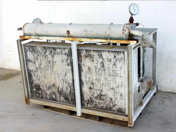 Copeland C2AH0750IFC001 condensing unit rear view showing two GE fan blade assemblies and condenser coil panels with heavy oxidation