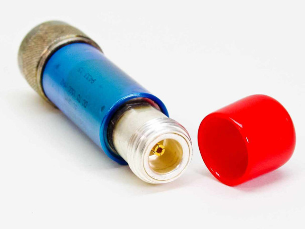 Mini-Circuits NAT-10 attenuator lying on side with red cap removed, exposing gold-pin N-female connector