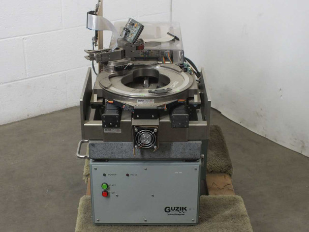 Guzik S1701 Hard Drive Spinstand — front view showing POWER and FAULT indicator lights, Guzik logo, and spindle platter assembly