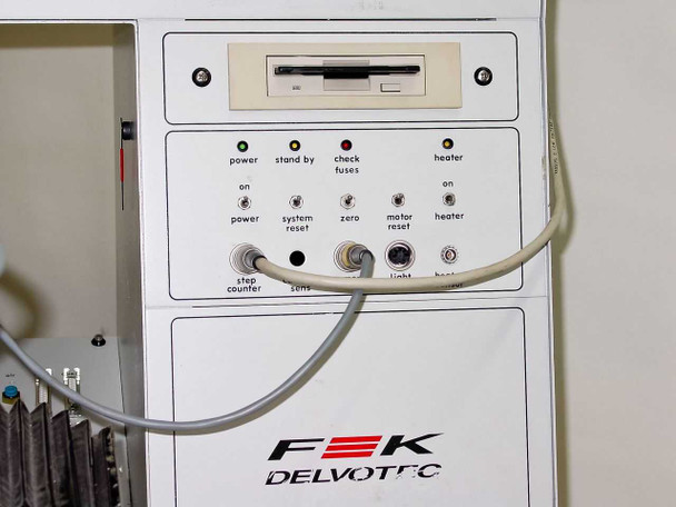 F&K Delvotec control cabinet front panel showing floppy drive, power/standby/heater indicators, and step counter controls