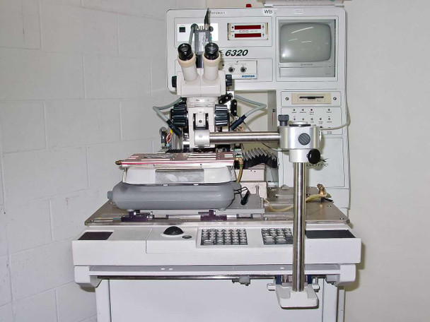 F&K Delvotec 6320 front view showing bonding station, 6320 label, Hitachi monitor, and Philips monitor mounted on cabinet
