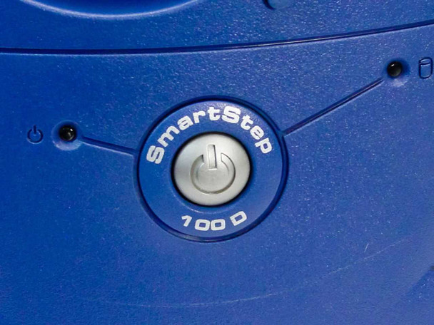 Dell SmartStep 100D power button close-up – illuminated SmartStep 100D branded power button on blue front bezel
