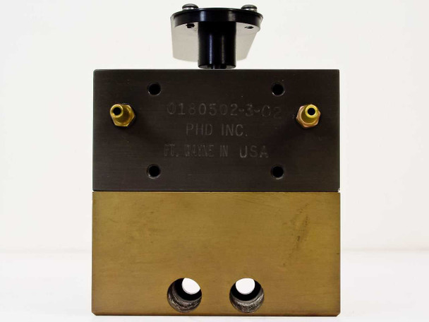 PHD Inc 0180502-3-02 — front face view showing engraved part number label, brass lower body with two large ports at base, and rotary platter hub at top