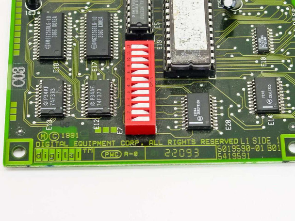 Digital DEC DE201 PCB closeup – board markings showing Digital Equipment Corp copyright 1991, part number 5019590-01 B01, PWC A-0, and red 12-position dip switch bank