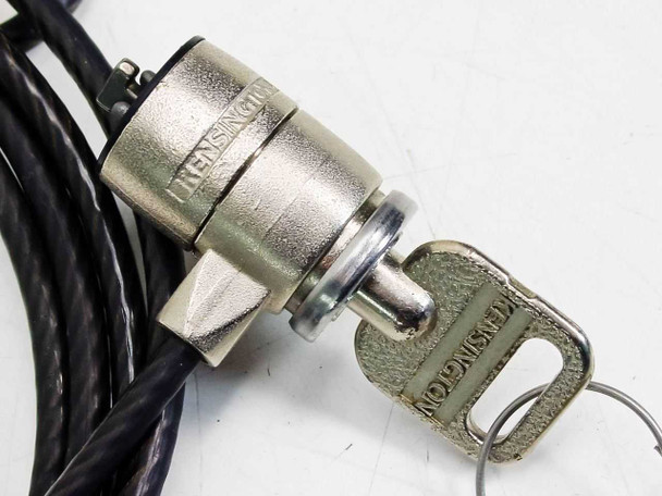 Kensington laptop cable lock – close-up of metal lock barrel showing Kensington branding with key inserted