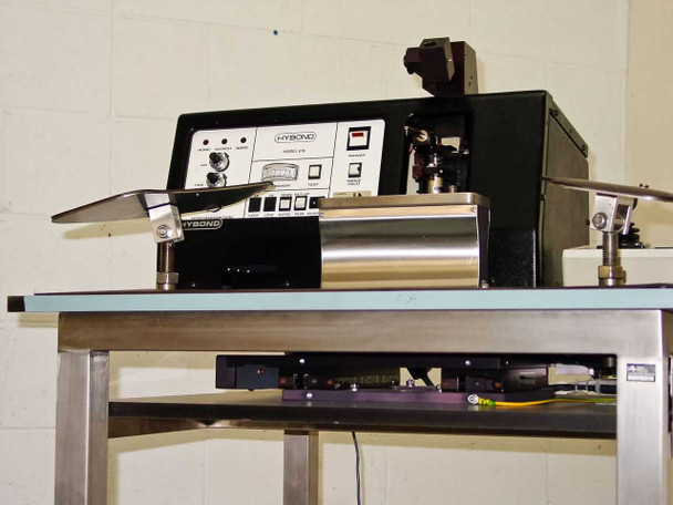 HyBond Model 616-12 bonder head and Parker X-Y linear stage close-up view from rear left, showing stainless work surface and wiring