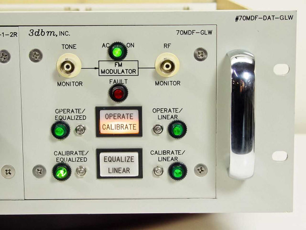 Close-up of second 3dbm 70MDF-GLW plug-in front panel showing #70MDF-DAT-GLW chassis label, FM Modulator indicators, Operate/Calibrate button illuminated amber, and green LED status lights