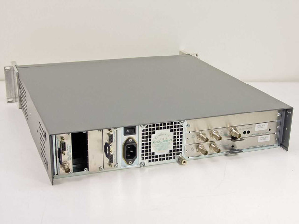 ComStream CM701 rear panel overview showing IEC AC inlet, cooling fan, BNC RF connectors, DB9 serial ports, and expansion card bay