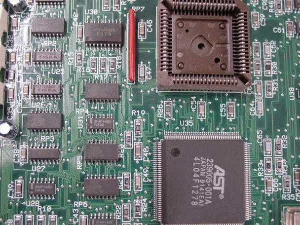 AST Research 386SX board chip detail — AST ASIC marked J290005-001A 4L04F1278 in PLCC socket, plus additional support ICs visible