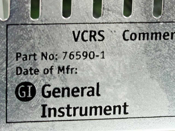 General Instrument VideoCipher II VCRS rear label closeup — Part No. 76590-1 and General Instrument GI logo embossed on rear chassis