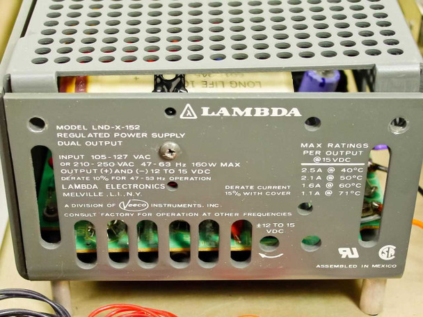 Lambda LND-X-152 regulated dual output power supply label showing 105-127V or 210-250V AC input, ±12-15 VDC output