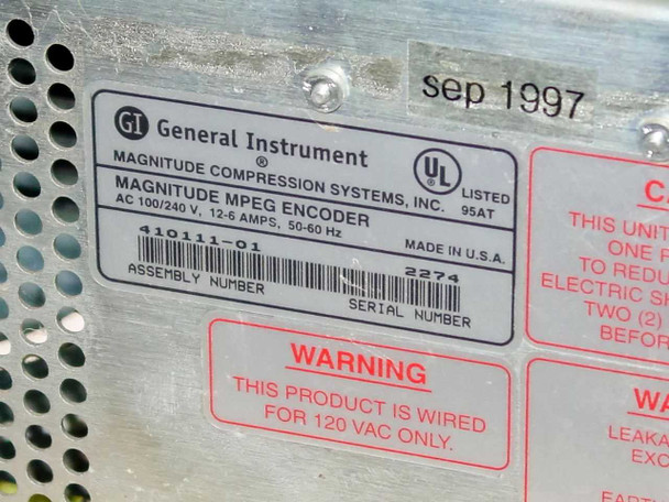 General Instrument CLI Magnitude MPEG Encoder 410111-01 — rating plate label: GI Magnitude Compression Systems Inc., 100/240V 12-6A 50-60Hz, UL Listed 95AT, Assembly No. 410111-01, Serial No. 2274, Made in USA, September 1997; warning label stating unit wired for 120VAC only