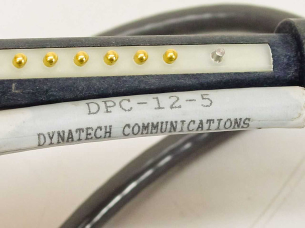 Dynatech DPC-12-5 label on cable connector showing model number and Dynatech Communications brand name, with gold pogo pin contacts visible