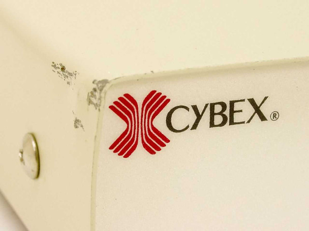 Cybex logo close-up on Commander Personal II KVM switch – shows paint chips and wear on top corner of beige metal enclosure