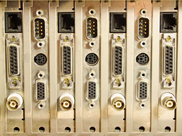 Cubix LCS Resource SubSystem rear card bracket close-up showing RJ45, DB9 serial, DB15, mini-DIN, and BNC connectors across multiple expansion cards