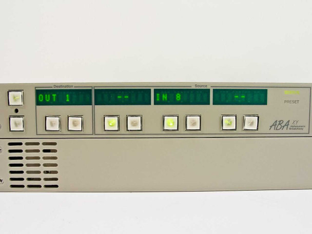 Leitch ABA XY front panel close-up showing green alphanumeric LED displays for Destination and Source with OUT 1 and IN 8 readout