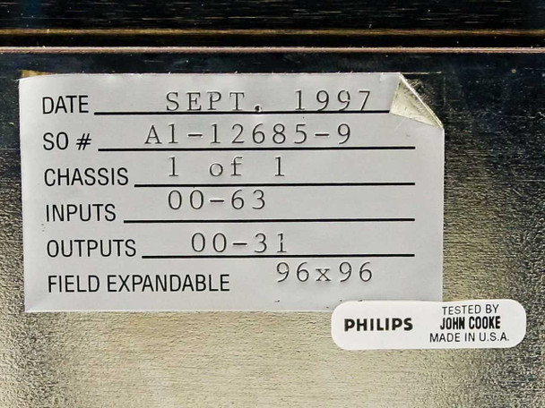 Handwritten configuration label showing date September 1997, sales order A1-12685-9, chassis 1 of 1, inputs 00-63, outputs 00-31, field expandable 96x96, tested by John Cooke