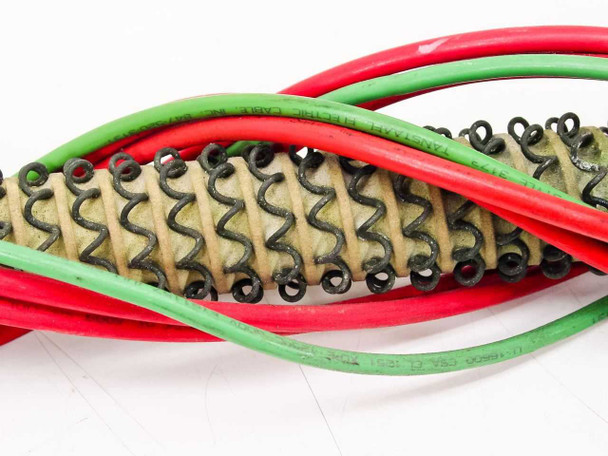 Close-up of Titan Industrial heating element coiled resistance wire construction with ceramic refractory body and red and green wire leads