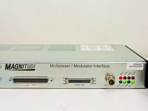 General Instrument Magnitude MMI+ – front panel close-up showing MAGNITUDE branding, Multiplexer/Modulator Interface label, ALARM CABLE port, HSSI I/O connector, EXT sync BNC, and MUX/DVB/SS/CLK/PLL/FRM/OLL LED status indicators