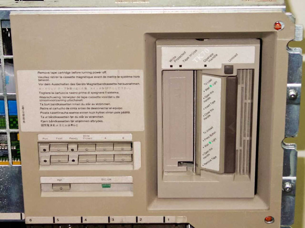 DEC TK70 streaming tape drive front panel with cartridge slot and multilingual removal warning label, installed in BA213 chassis