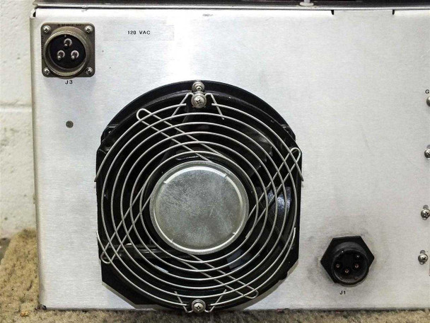 Rear of TWTA power supply close-up — 120 VAC label, J3 circular power input connector, large axial fan with guard, and J1 connector