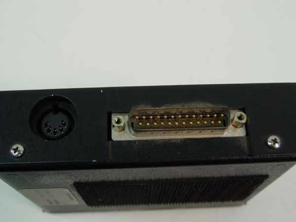 Black Box AC223A KVM Remote Module – left side showing Mini-DIN 6-pin keyboard port and DB25 connector with dust and light oxidation on pins
