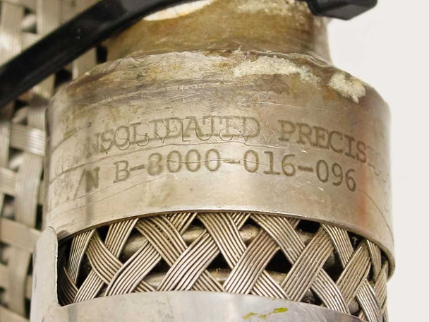 Stamped label on fitting of Consolidated Precision B-8000-016-096 braided vacuum hose showing manufacturer name and part number