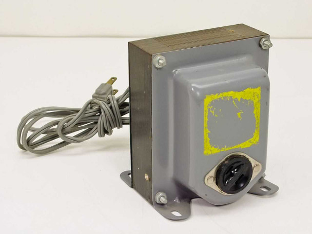 Switchable AC transformer front view — gray steel enclosure with AC outlet receptacle, mounting feet, power cord, and yellow-painted-over label