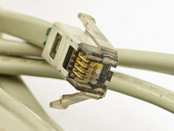 Close-up of RJ11 modular connector end of IBM 73G8856 POS cable showing gold contacts and clear plastic housing
