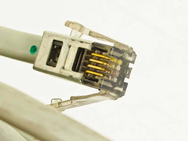 Close-up of IBM 6316839 RJ-style modular plug end showing yellow gold contacts