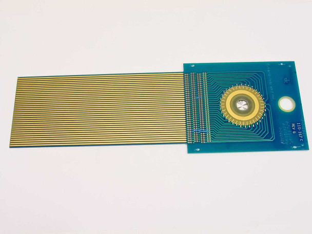 110-147C Rev G DAS Device PCB reverse side view showing gold finger flex ribbon extending left and radial contact array visible on right side of teal board
